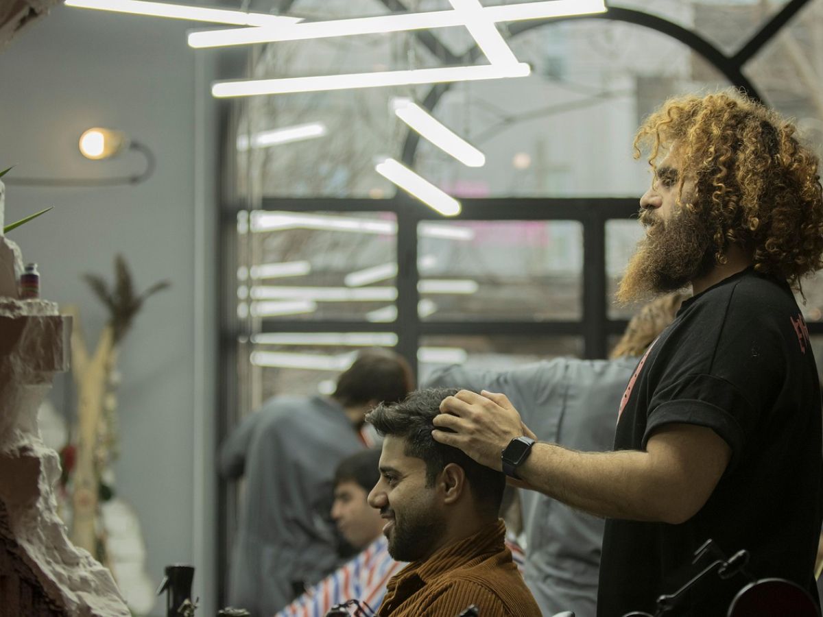 A barber cutting a customer’s hair